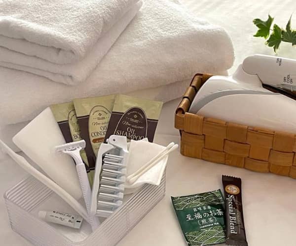 ホテルのアメニティセット、タオル、シャンプー、カミソリなどが並べられている